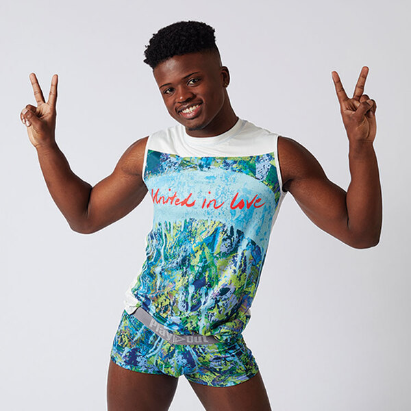 African American gay model wears Play Out United In Love Muscle tank and gives the peace sign.